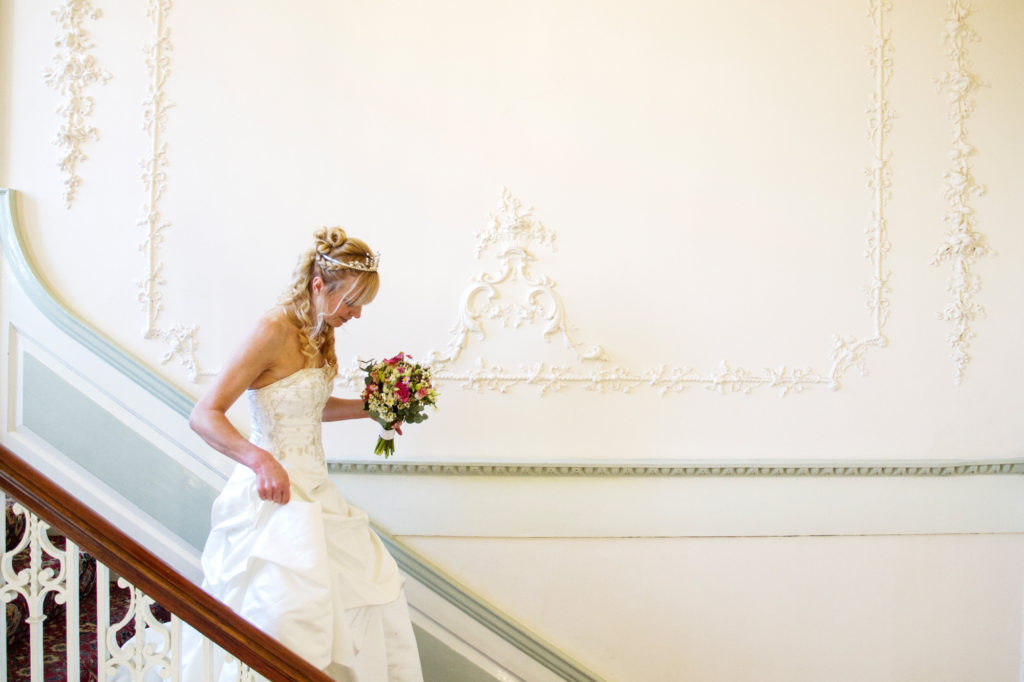 A gorgeous bride descends the 1764 staircase
